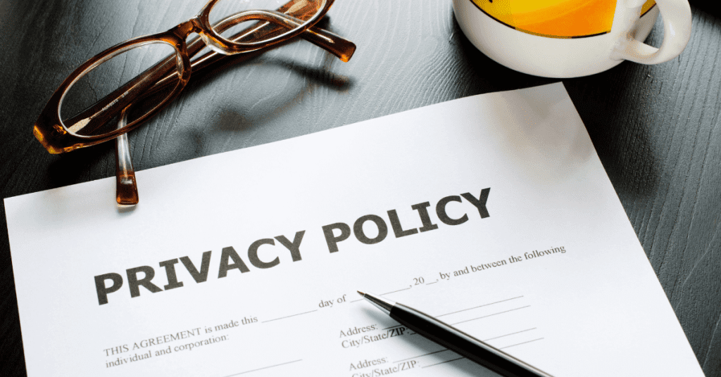 Privacy policy contract with pen, eyeglasses, and a cup on the table